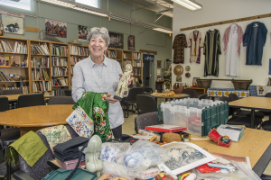 Sandy Shepard, director of RISE Library, sorts through boxes of donated artifacts. (Photo by Jason Halley)