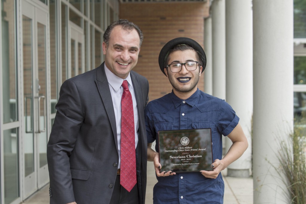 Ahmad Boura (left) presents Severiano Christian (right) with the Chris Hilbert Chico State Friend Award as students are honored at the 27th Annual University Awards Reception as part of Founders Week on Tuesday, April 12, 2016 in Chico, Calif. (Jason Halley/University Photographer)