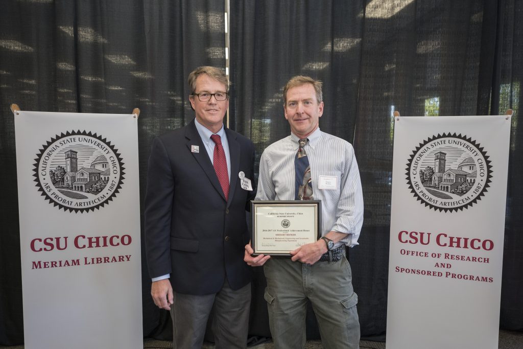 Gregory Watkins (right) is presented with the Professional Achievement Honor award by Kevin Kelley, interim associate vice president of the University's Office of Research and Sponsored Programs.
