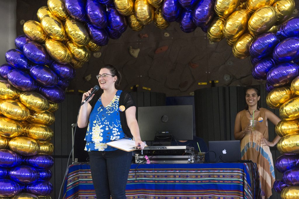 Author Jessica Candela (left) stands in front of a balloon arch at the Back-To-School Connect event.