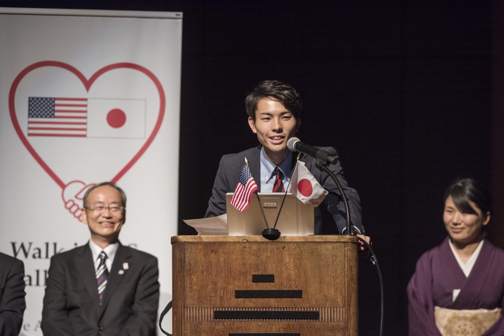 Hokuto Suzuki speaks at the podium
