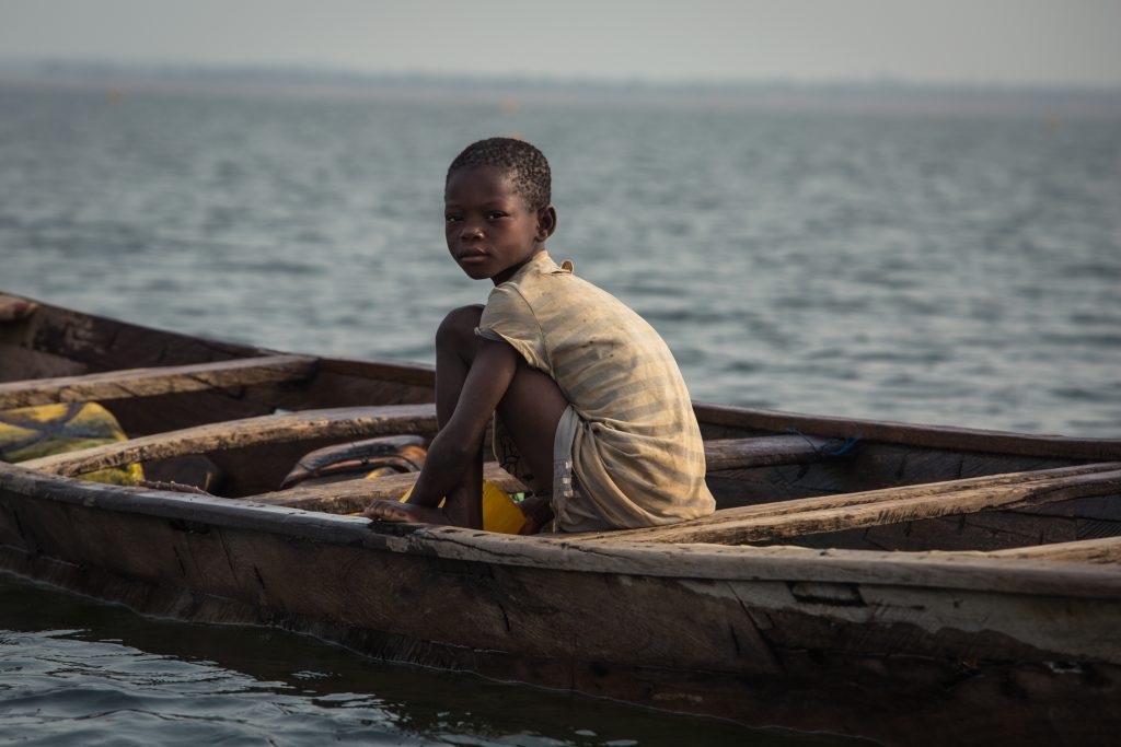 A child sits on a fishing vessel on Lake Volta. (Photo courtesy of Emily Teague)