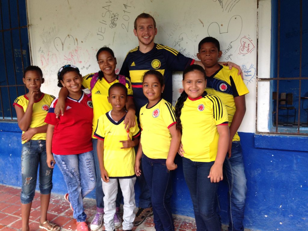 Johnson stands with a group of his young students in Colombia.