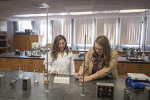 Faculty Lisa Kendhammer works with Jessica Gonzales to conduct a research project in chemistry