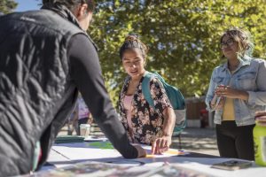 Jessica Gonzales learns about "Indigenous People's Day" at a student table on campus.