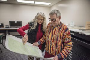 Librarian Joe Crotts (at right) and his wife Brenda examine a document in Meriam Library.