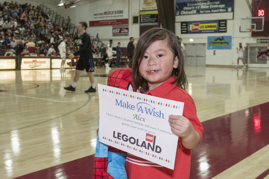 Alex holds up his Make a Wish certificate saying he is going to LEGOLAND
