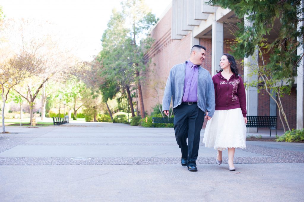Chris and Jessie Mendoza on their wedding day holding hands, walking on the Chico State campus.