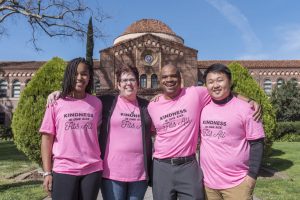 Donna Humphrey and three colleagues wear their pink shirts in front of Kendall Hall. 