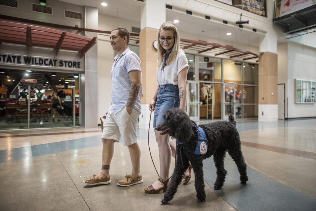 Distance learning student Taylor Coutts (center), along with her husband, Michael, and service dog, Davy, visited the Chico State campus for the first time in May, just days before she received her degree in sociology.