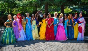 Women in Disney character costumes pose for a photo.