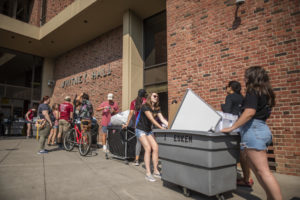 Students push move-in bins into Whitney Hall