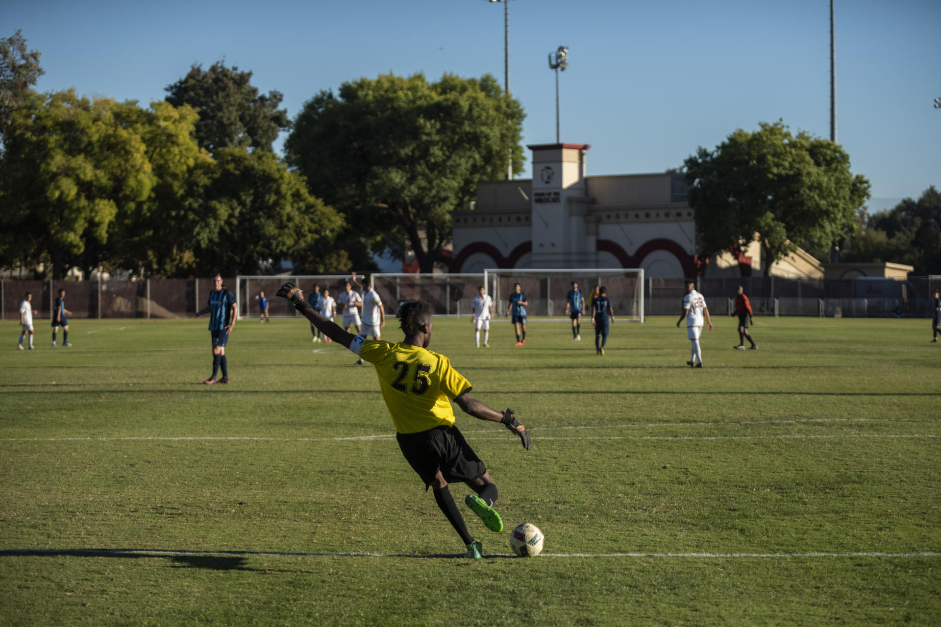 Chico State goalkeeper Damion Lewis sends a goal kick as his teammates await.