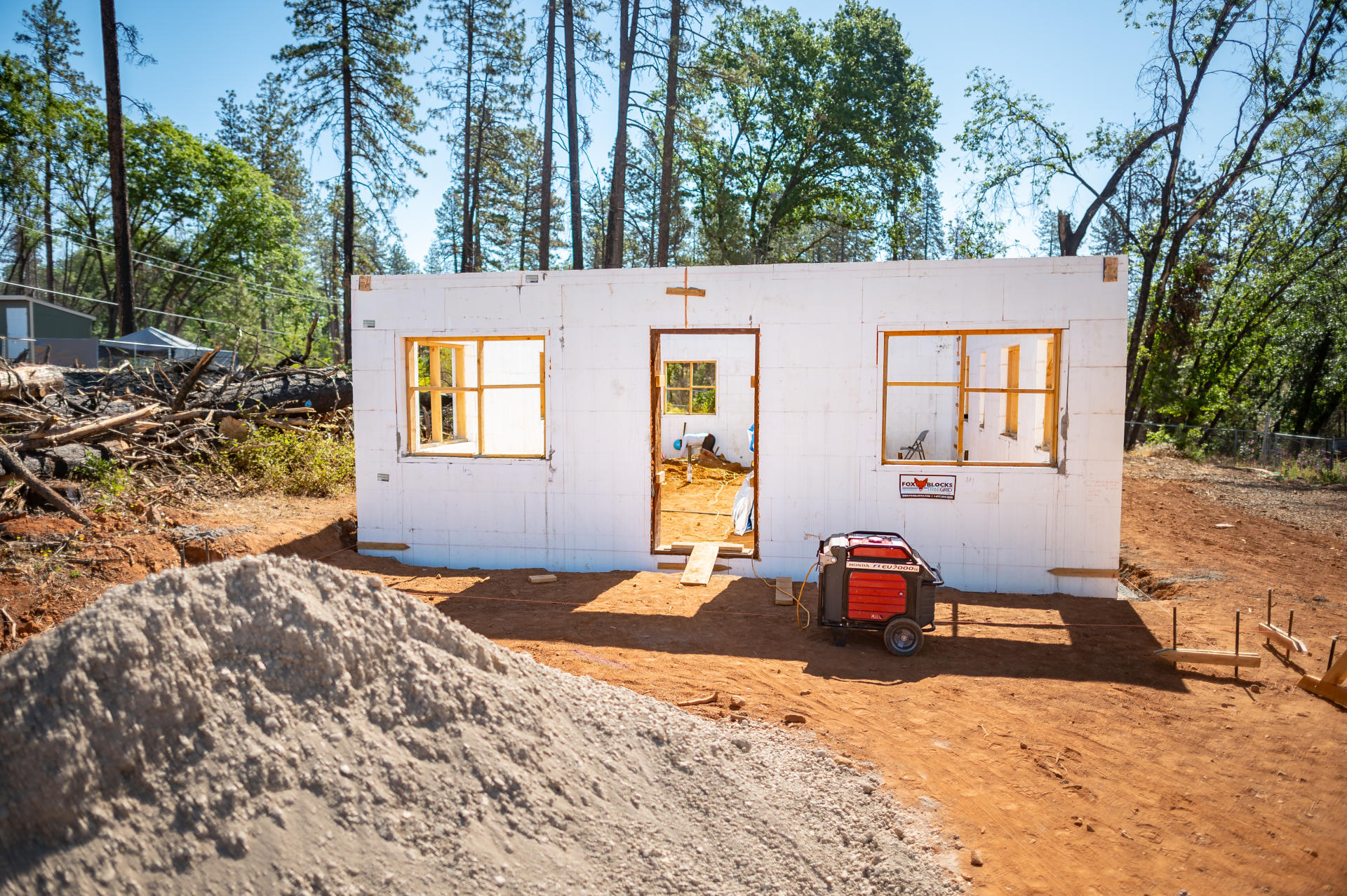 A new home starts to take shape using insulated concrete forms but still lacks a window, doors, and a roof.