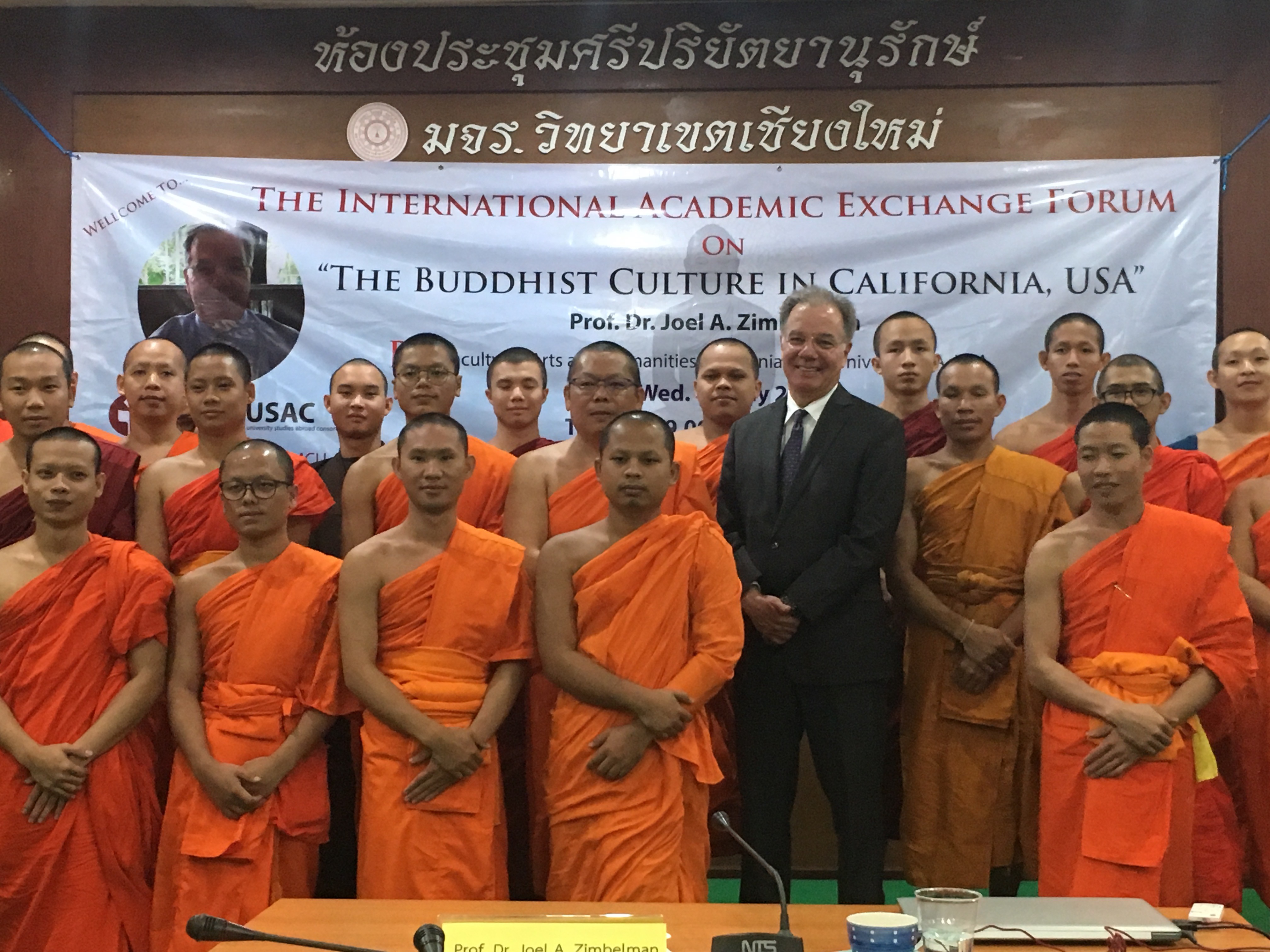 Chico State professor Joel Zimbleman stands with a group of monks during his time teaching overseas.