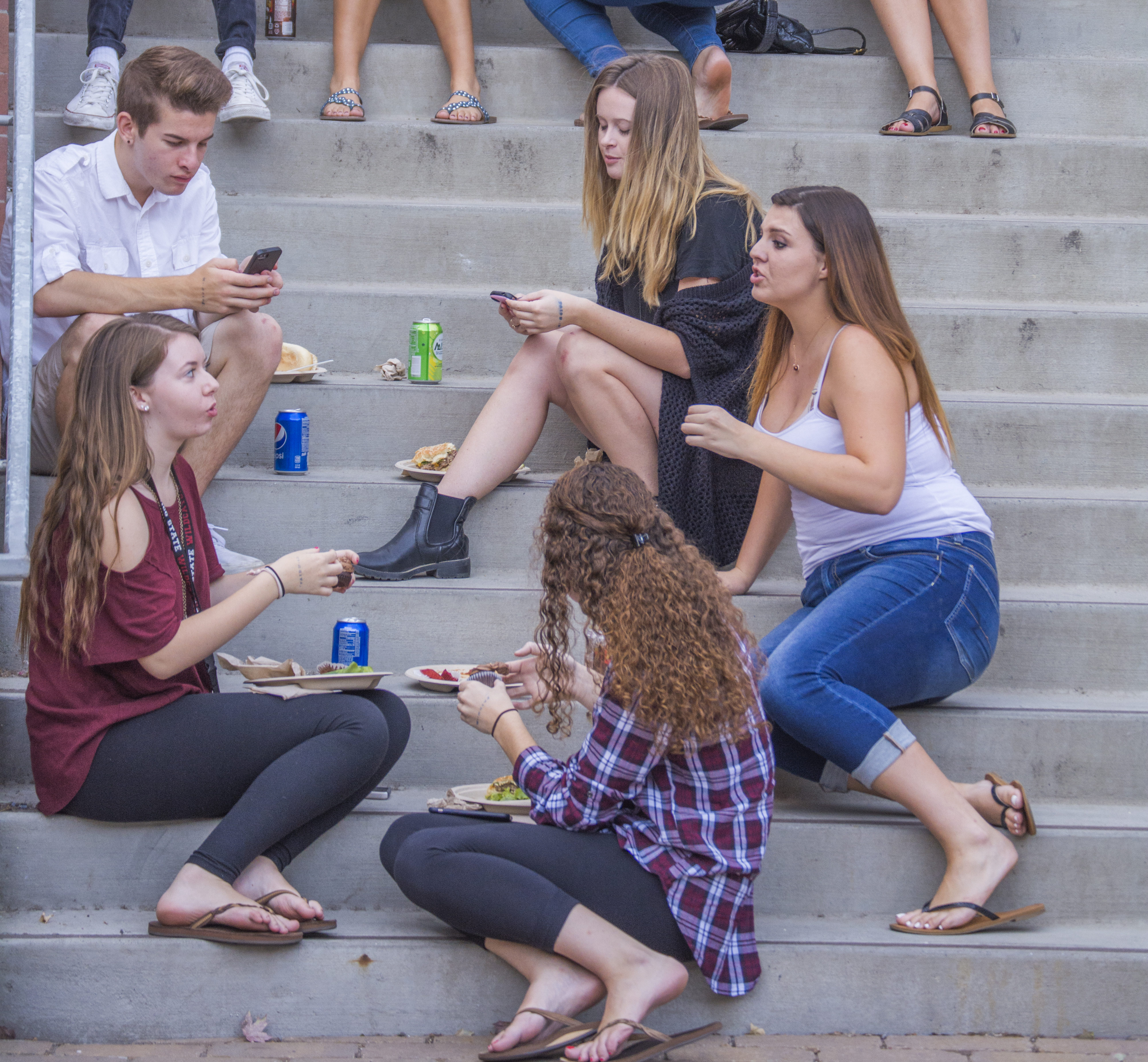 Students hang out and eat on the steps outside Sutter Hall