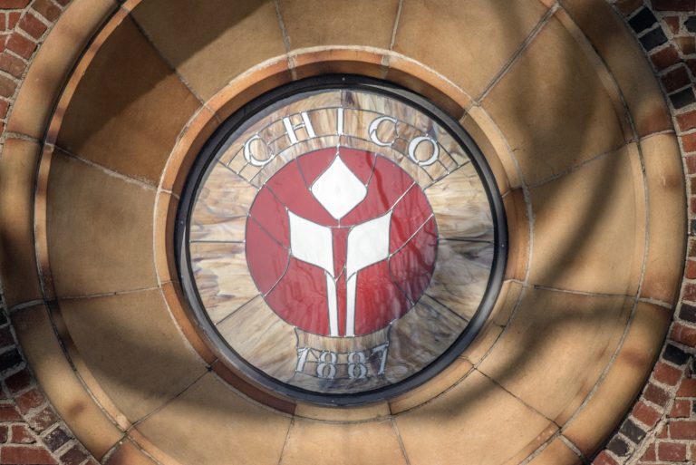 The flame logo emblem is seen in stain glass on Kendall Hall