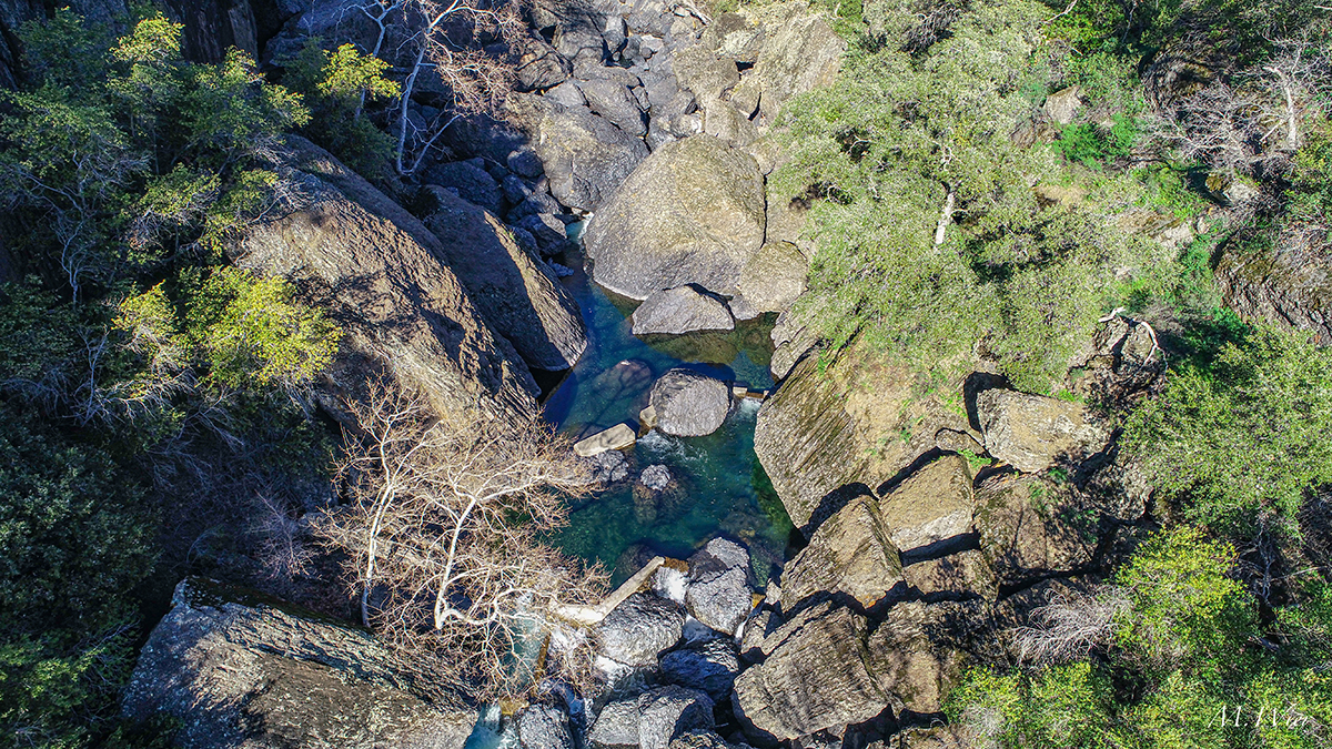 A drone shot of a canyon and creek