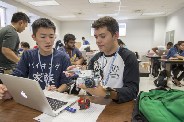 Ler Lor (left) and Adrian Vera (right) work on lego robotics as part of Upward Bound that focused on math, science, engineering and information technology (STEM) program on Wednesday, July 15, 2015 in Chico, Calif. (Jason Halley/University Photographer)