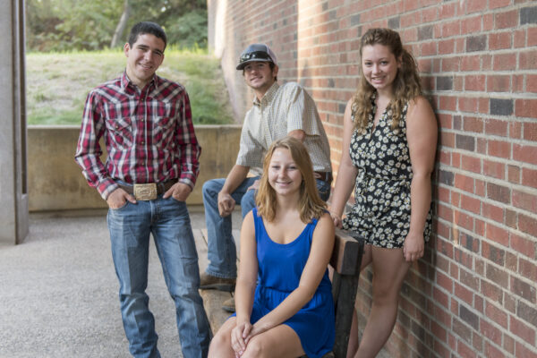 Photo of the four 2015 Bell Presidential Scholars, pictured together, smiling, in front of the College of Agriculture.