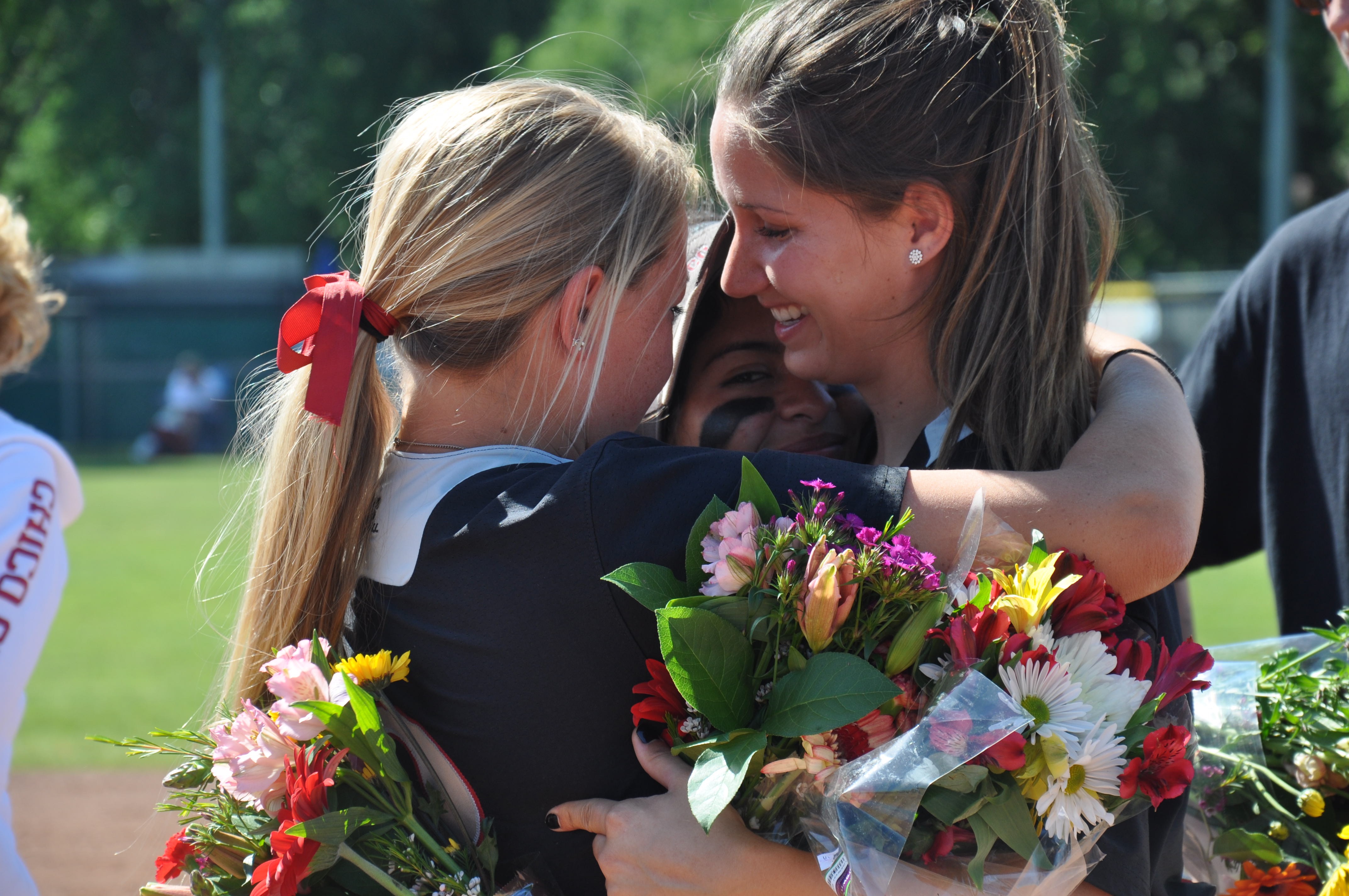softball players embrace to show support
