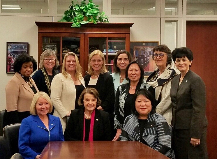 President Hutchinson and 10 of the 12 CSU women presidents sit around Dianne Feinstein at a conference table.