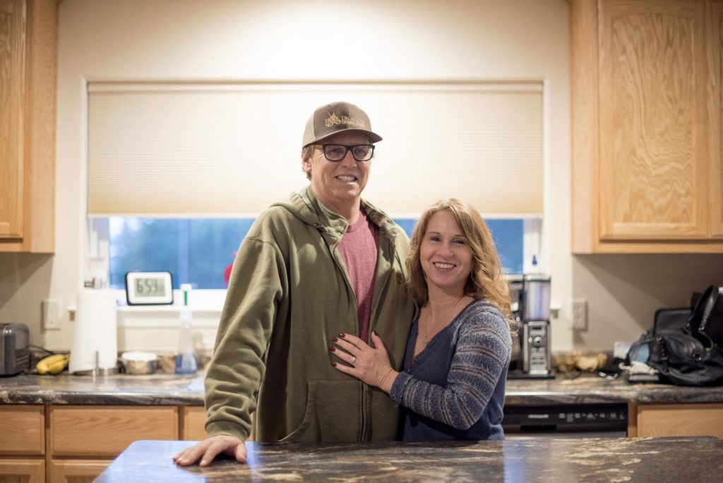 Kelly Shields and his wife, Sandy, stand in front of an island in the studio apartment they are living in while they wait to rebuild their Paradise home.