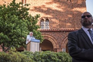 Bernie Sanders speaking at a podium in front of Laxson Auditorium.