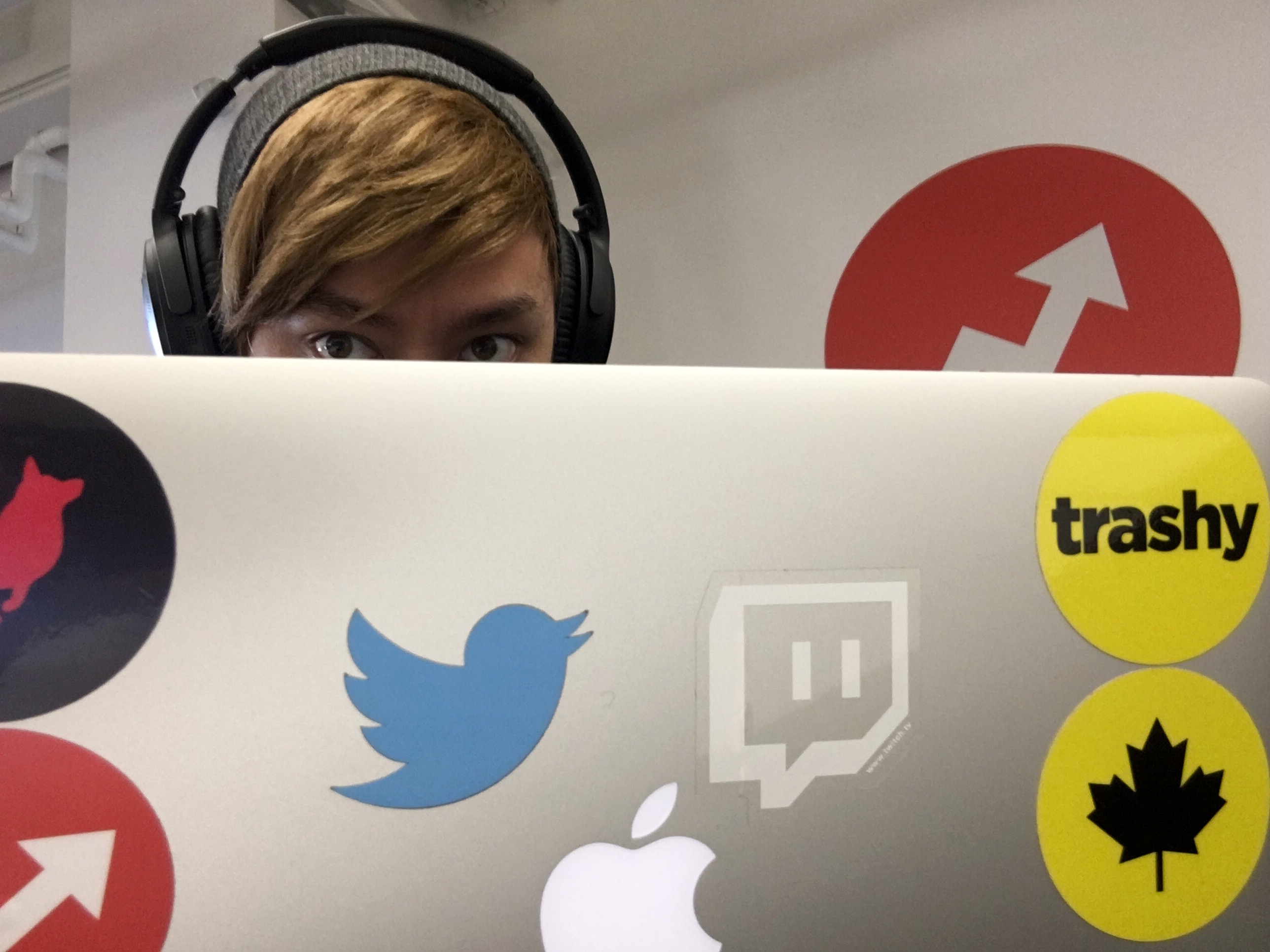 Jeff Barron, behind a laptop covered in social media logo stickers