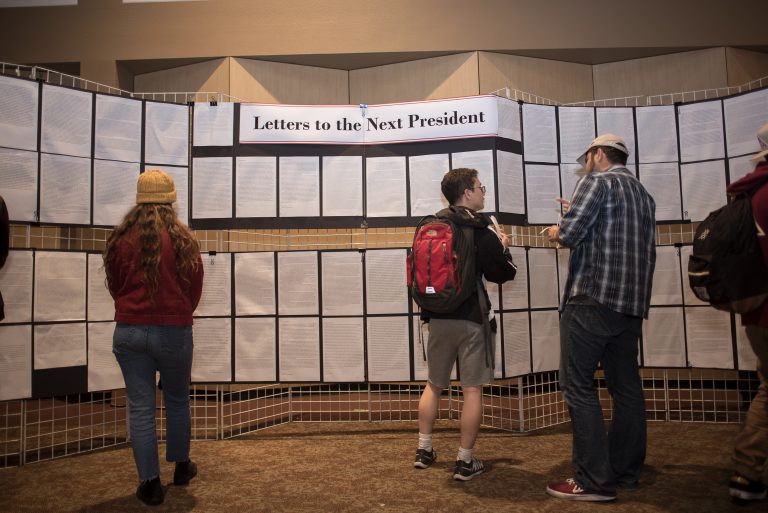 Students look at and discuss Letters to the Next President, a project by First-Year Experience, at Wildcats Vote last month (Jessica Bartlett/Chico State student photographer)