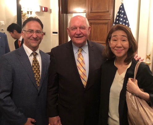 Steve Vargas, left, stands with US Secretary of Agriculture Sonny Perdue and Yumi Kojima with the USA Rice Federation.