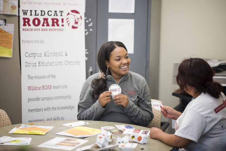Peer Educator Janieil Harris talks with a fellow student at the Campus Alcohol and Drug Education Center.