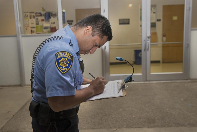 A member of the University Police Department makes marks on a list during a safety walk in 2015. A spring safety walk will take place around the University neighborhoods on Tuesday, March 13.