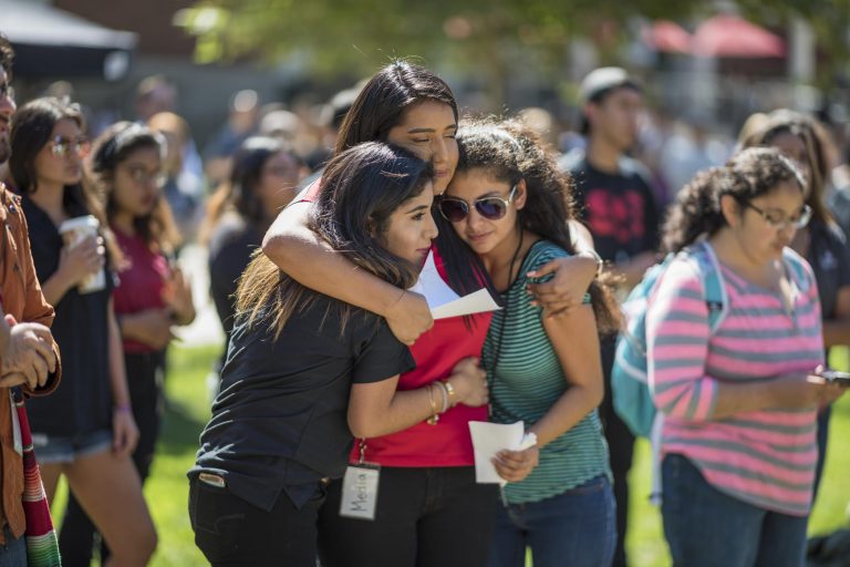 Students embrace at a rally held on campus.