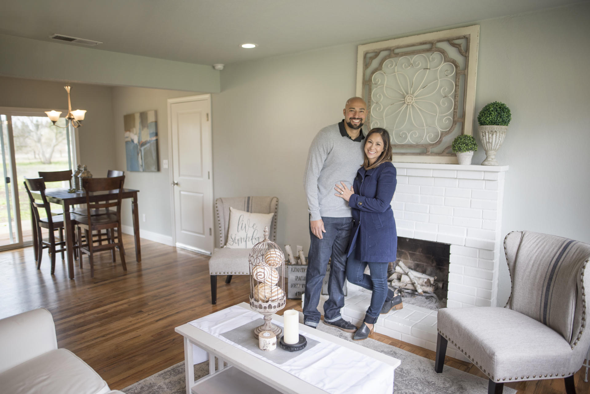 David and Chenoa Rivera stand in the living room of a recently flipped home.