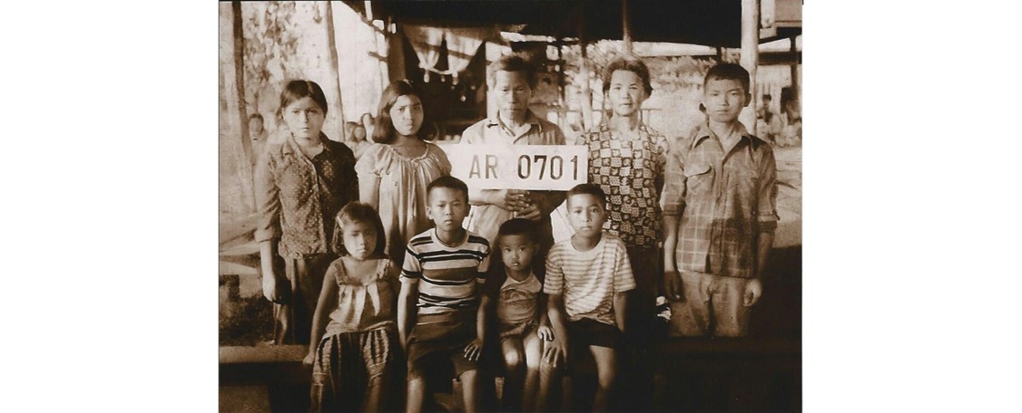 Neil and his family pose for a photo at a refugee camp in Thailand.