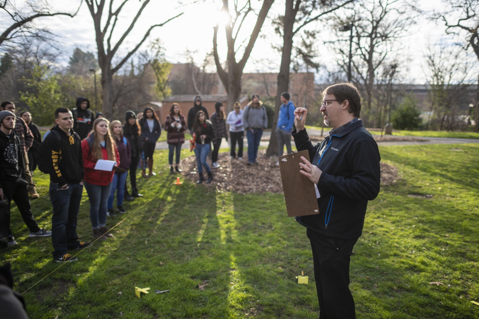 Eric Bartelink speaks to a group of forensic anthropology students at a mock crime scene on the Butte Hall lawn.