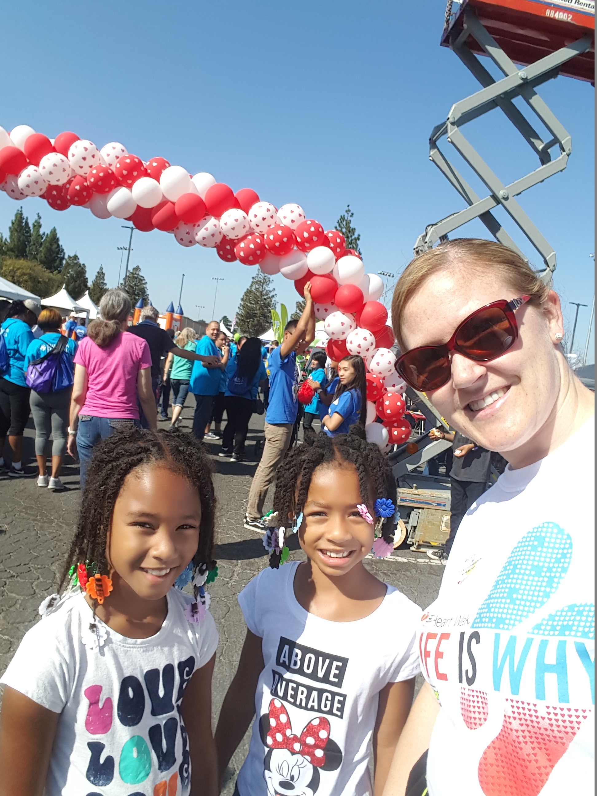 Casey takes a selfie with two young girls at the Heart Walk