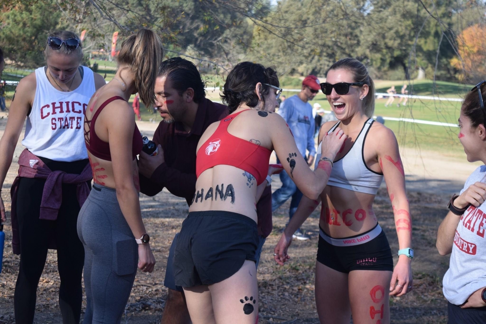 MacKenzie Deeter laughs as teammates cover her in body paint before a track meet.