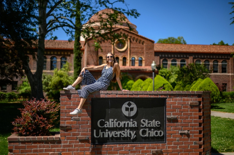 Lilah Nielsen poses on top of the California State University, Chico sign.