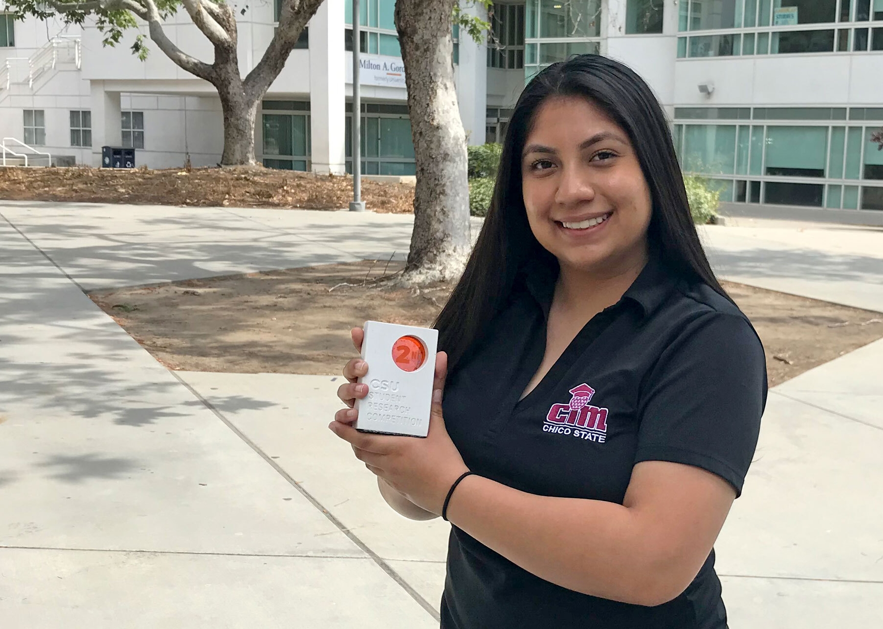 Eliana Aguilar poses with a trophy from the CSU Student Research Competition.