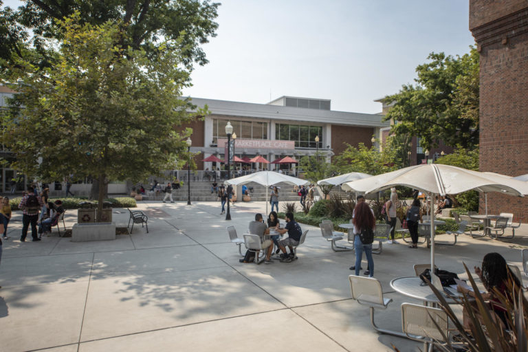 Students mingle in the beautiful sunshine of the Chico State campus on the first day of classes in fall 2018.