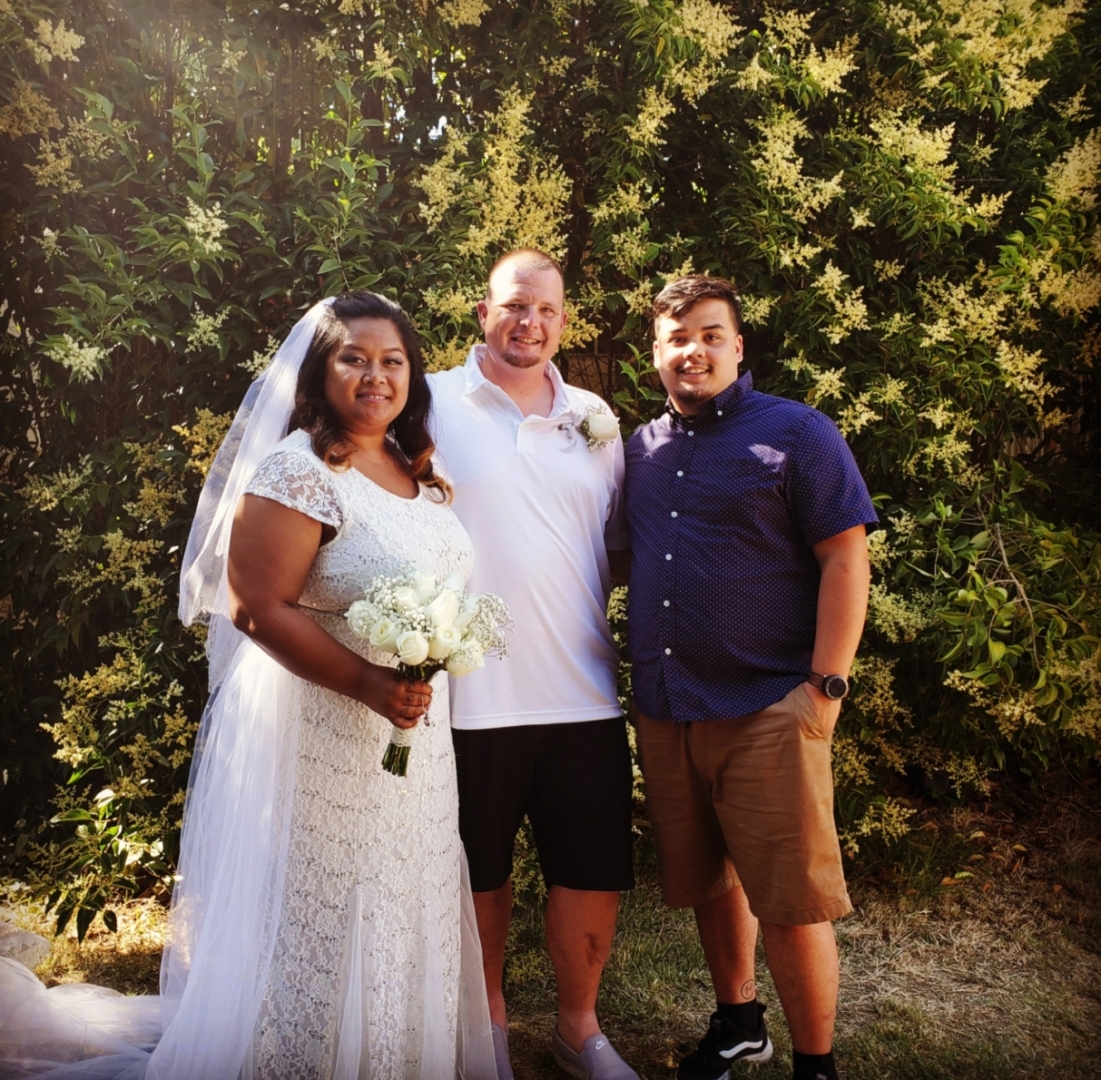 Lobsien stands with a bride and groom, his longtime mentor.
