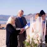 Wayne Edmiston and his wife Jacque officiating a wedding on Pismo Beach.
