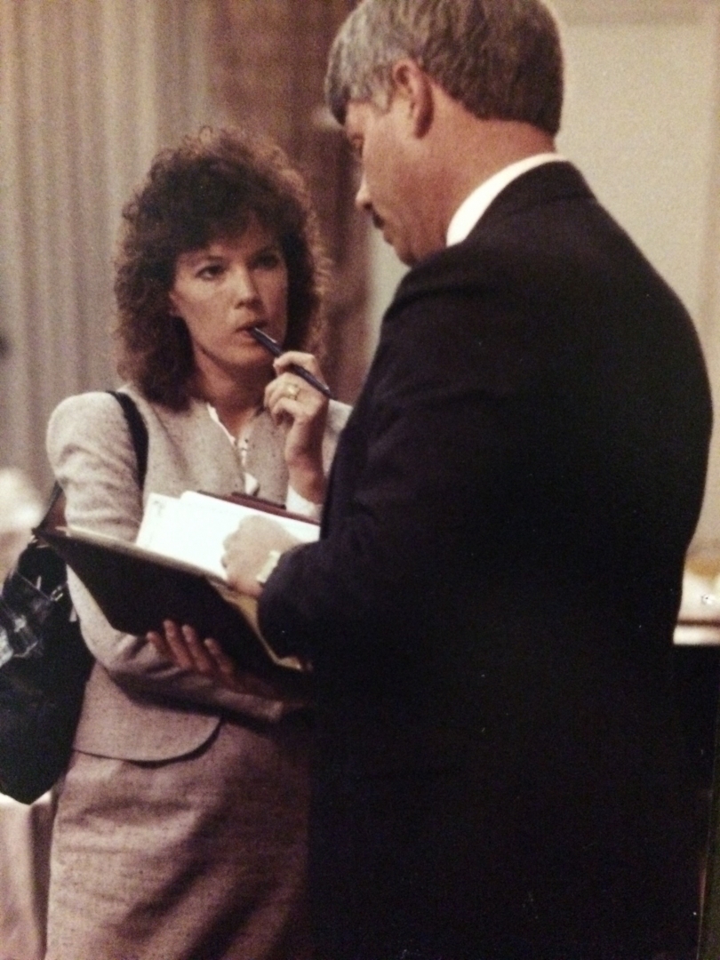 A woman reporter is intently listening to a man answering her questions.