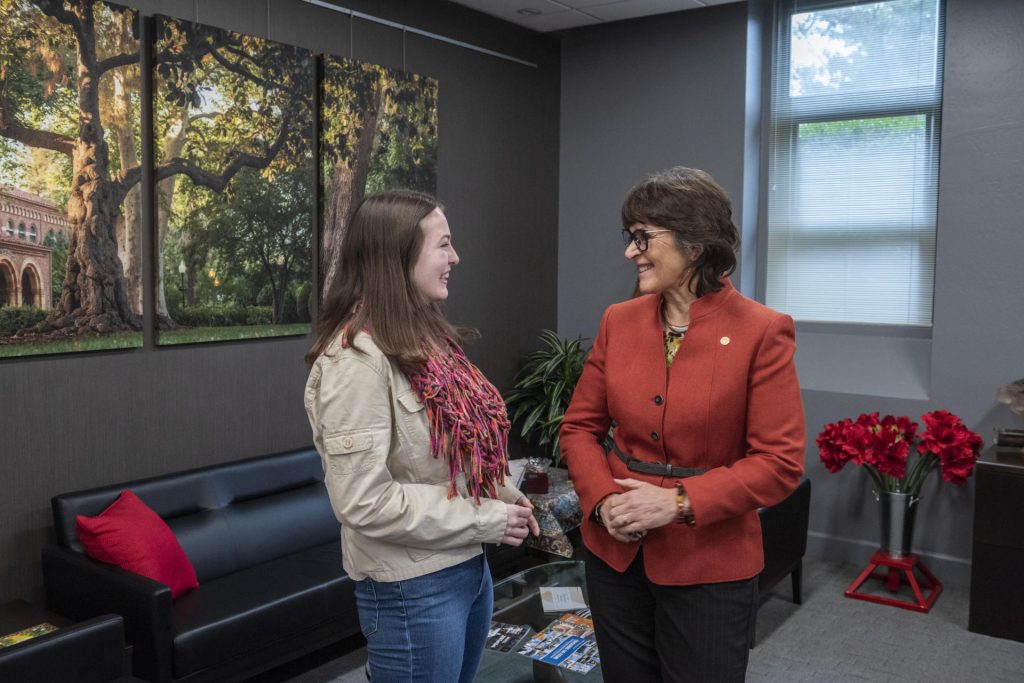 Student Emily Zarback smiles with Chico State President Gayle Hutchinson.
