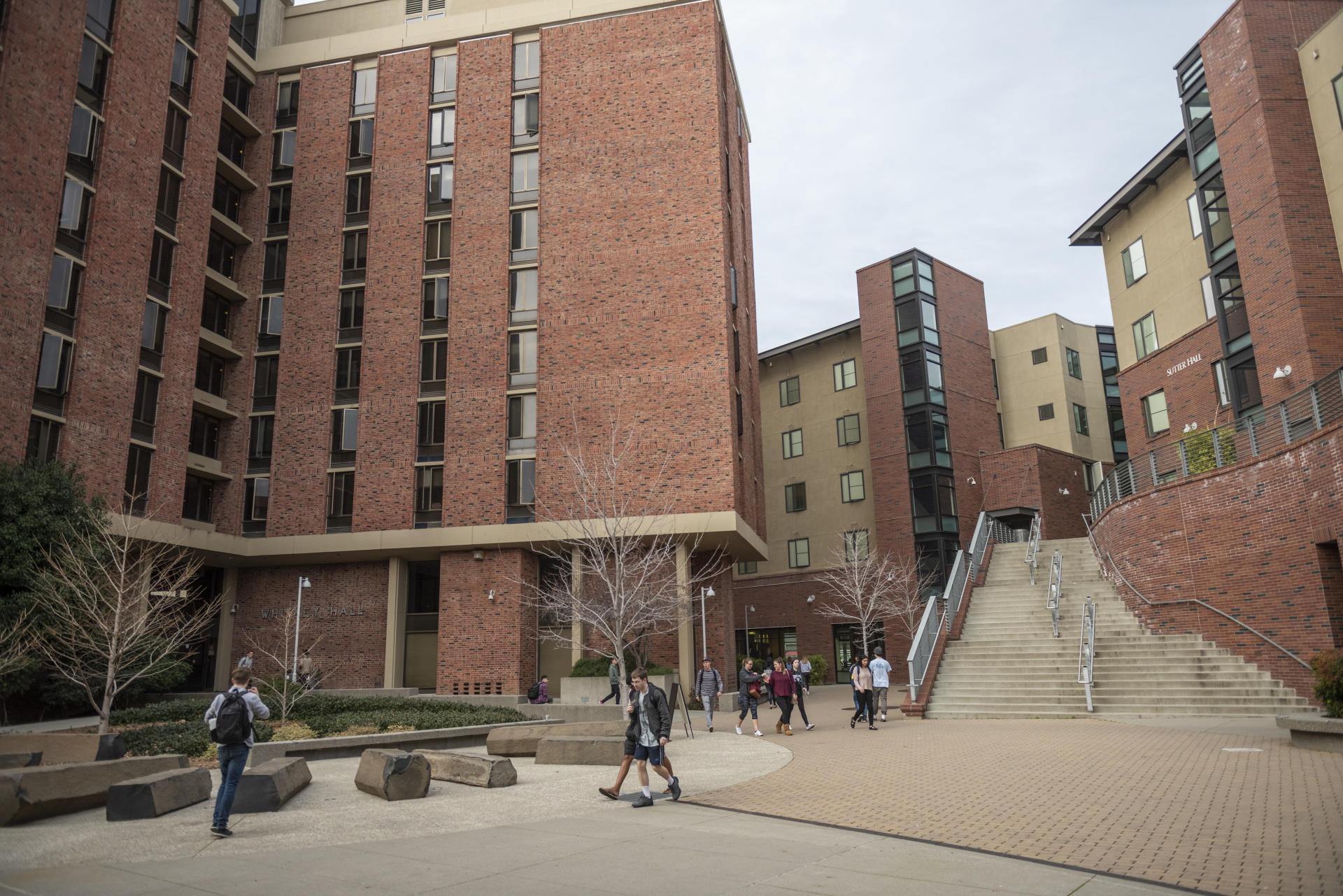 Students walk near the on-campus student housing buildings.