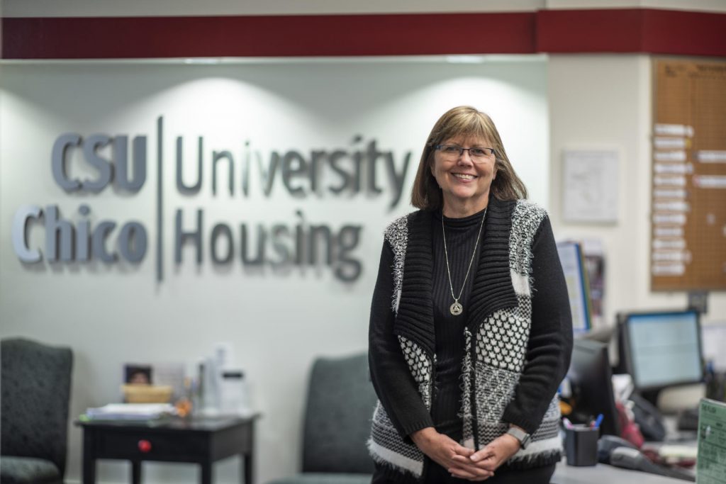 Connie Huyck stands in Chico State's office of Student Housing.