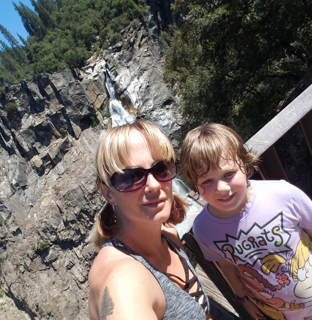 Sabrina Hanes and her daughter, Aroara, stand at the viewing platform with Feather Falls behind them.