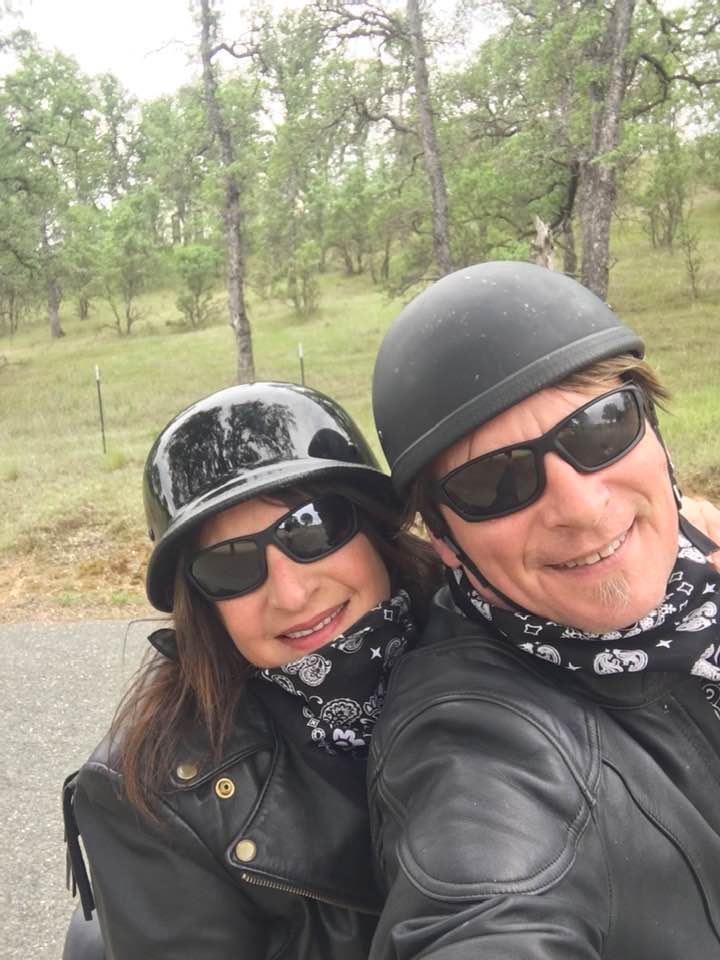 Mandy Feder-Sawyer and her husband, Larry, take a selfie wearing motorcycle helmets on a ride.